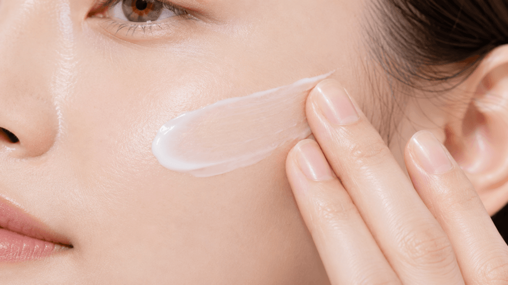 Close-up of lightweight Korean sunscreen blending into healthy skin